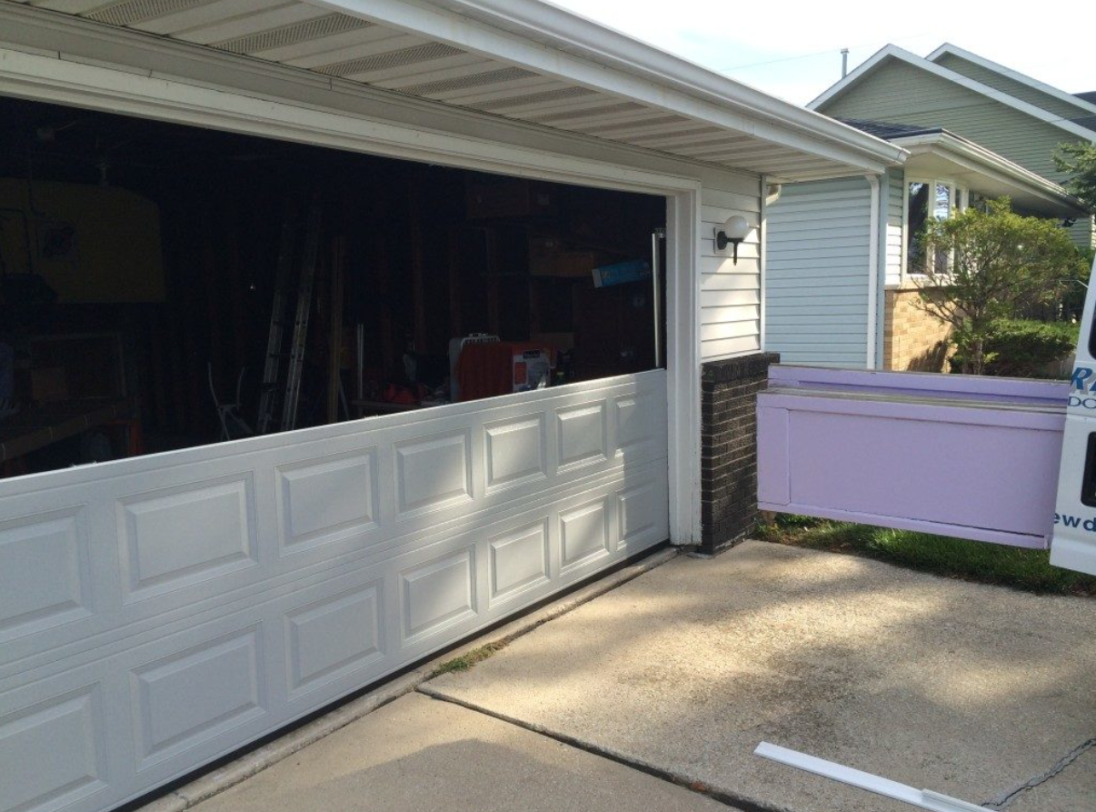 Technician performing Garage Door Panel Repair for a residential property