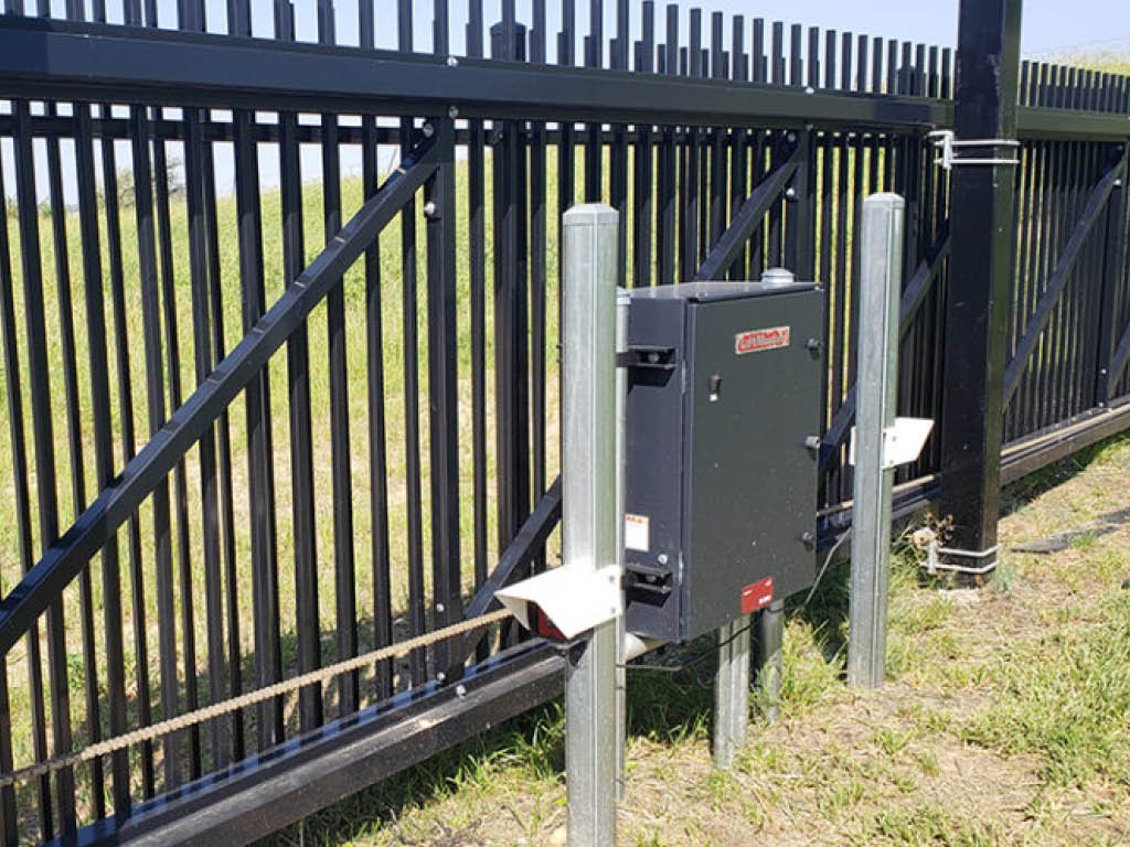 Technician repairing an automated gate to ensure smooth functioning and security