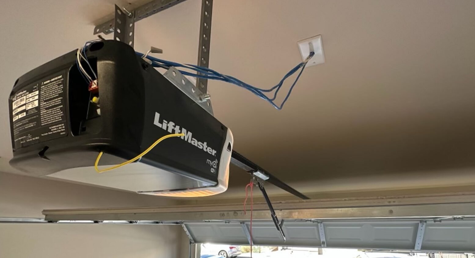 a professional technician from Garage Door Repair Foxleigh LLC expertly repairing a garage door opener system, highlighting their expertise in garage door opener repair services.