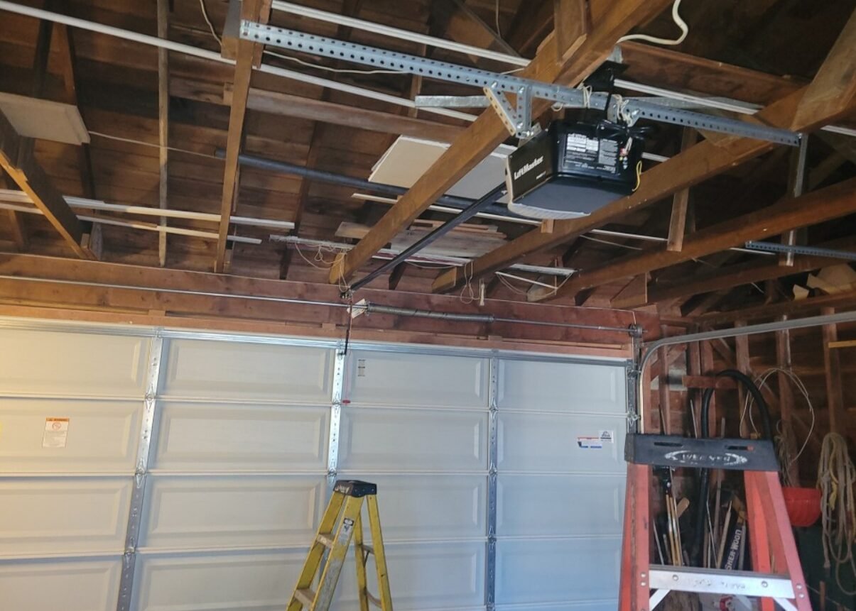 Professional technician performing garage door repair service at a residential property in Foxleigh