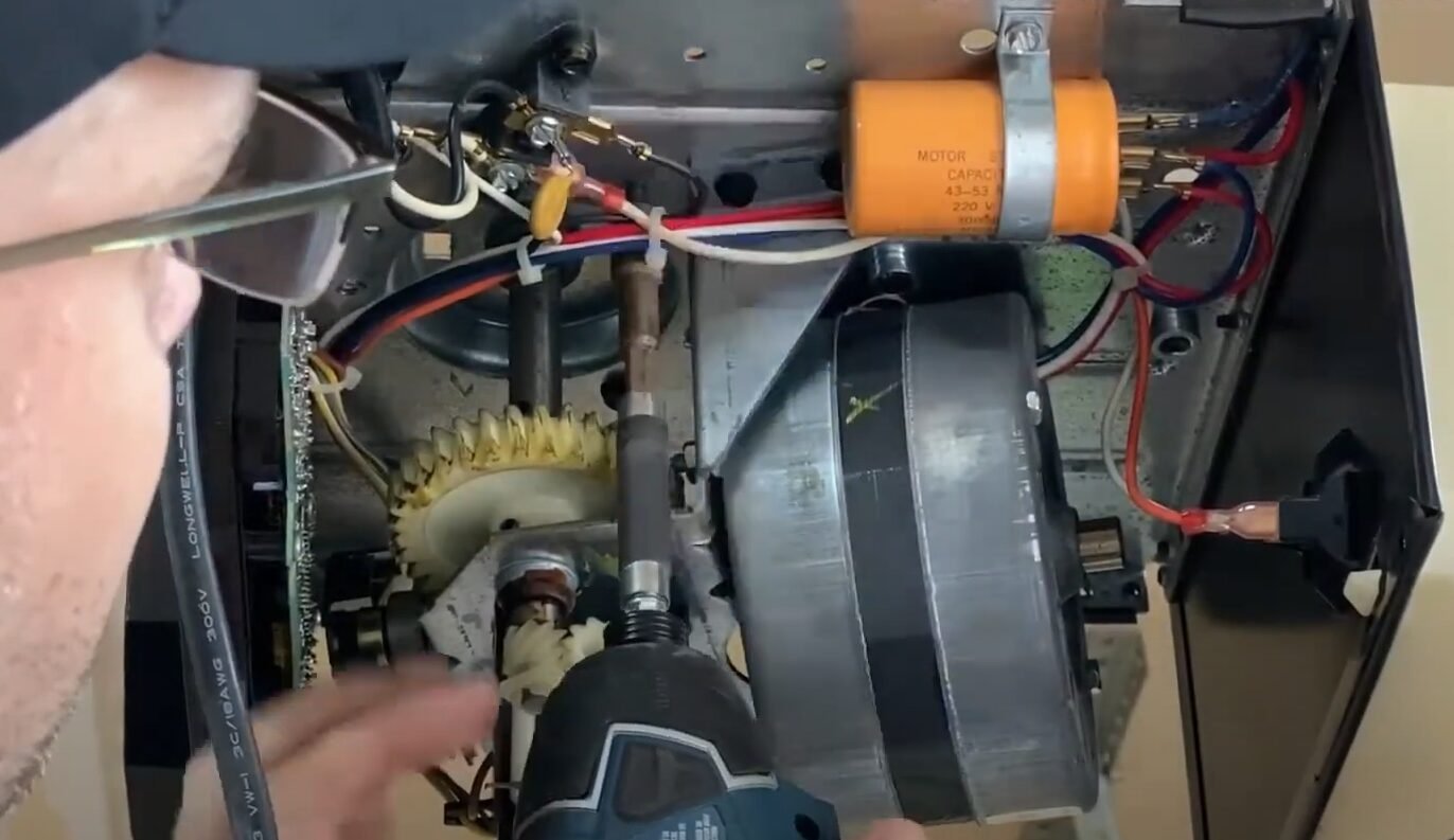 a technician conducting garage door opener repair, showcasing tools and parts used in the process, in front of a residential garage in Foxleigh.