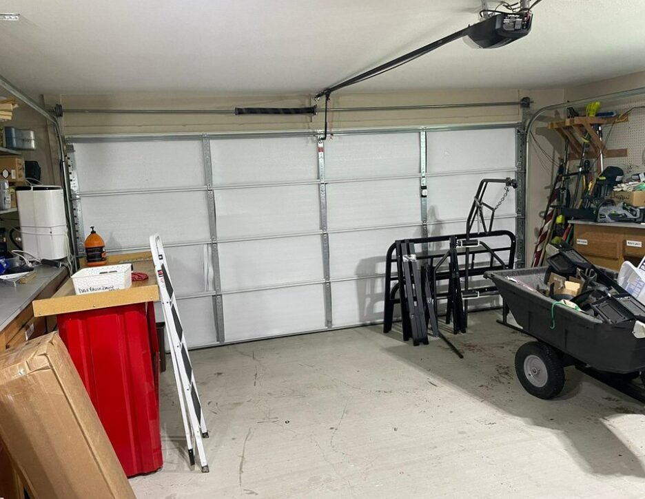 Technician performing garage door repair service at a residential home in Foxleigh, showcasing professional tools and expertise for reliable garage door maintenance and repair.