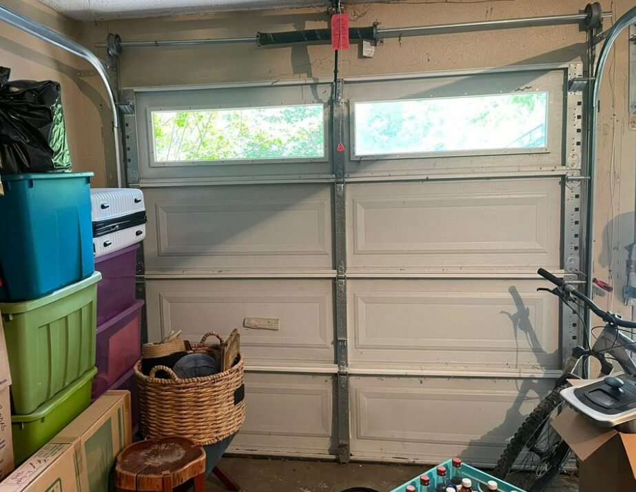 Technician performing professional garage door repair in Foxleigh, showcasing tools and expertise for reliable garage door maintenance and fixes.