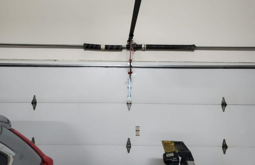 "Professional technician performing garage door spring repair service in Foxleigh