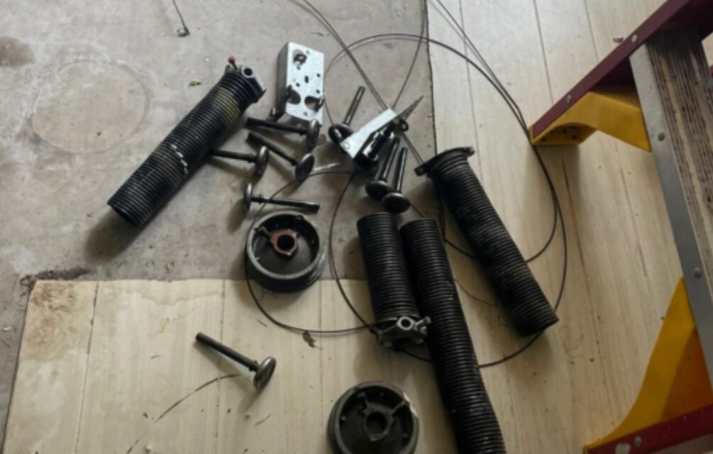 Professional technician performing garage door spring repair at Garage Door Repair Foxleigh